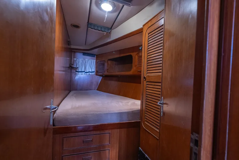 4 Knots Yacht Photos Pics Cozy cabin interior of 1990 Hylas 51 yacht with wooden furnishings.