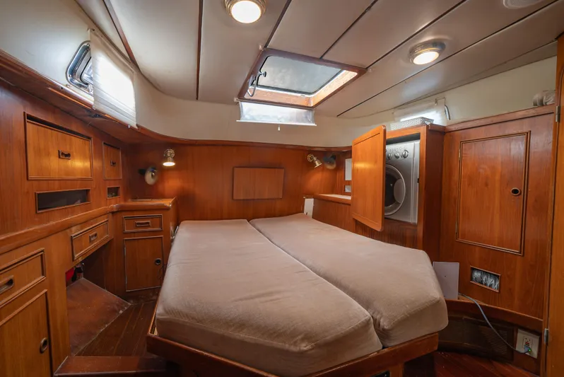 4 Knots Yacht Photos Pics Cozy cabin interior of 1990 Hylas 51 yacht with wood paneling and skylight.