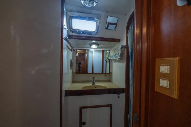 4 Knots Yacht Photos Pics Bathroom interior of 1990 Hylas 51 yacht with sink and mirror.