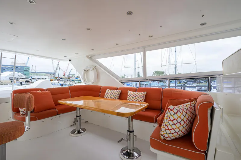 Miss Dunia Yacht Photos Pics Luxurious 2008 Hargrave Raised Pilothouse yacht interior with orange seating and wooden table.