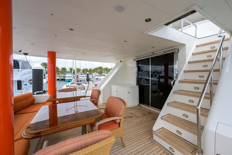 Miss Dunia Yacht Photos Pics 2008 Hargrave Raised Pilothouse yacht deck with seating, table, and stairs.