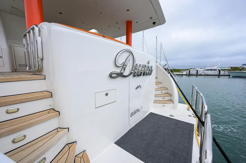 Miss Dunia Yacht Photos Pics 2008 Hargrave Raised Pilothouse yacht with elegant wooden steps and marina view.