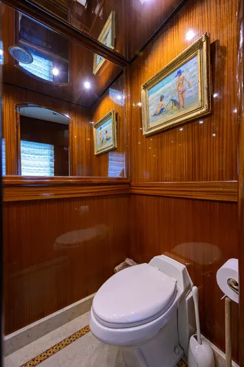 Miss Dunia Yacht Photos Pics Luxurious 2008 Hargrave Raised Pilothouse yacht bathroom with wood paneling and framed artwork.