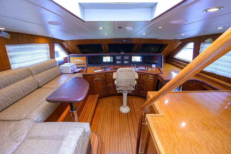 Miss Dunia Yacht Photos Pics Luxurious 2008 Hargrave Raised Pilothouse interior with wood finishes and navigation equipment.