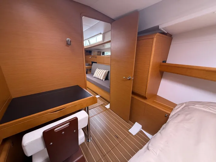 Kahuna Yacht Photos Pics Interior of 2011 Jeanneau 409 yacht, featuring wood finish, desk, and cozy seating area.
