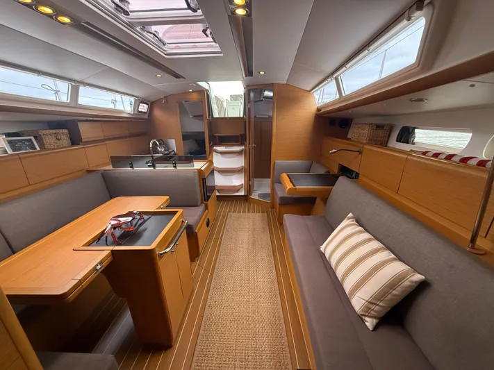 Kahuna Yacht Photos Pics Interior of 2011 Jeanneau 409 sailboat with modern wood finish and comfortable seating.