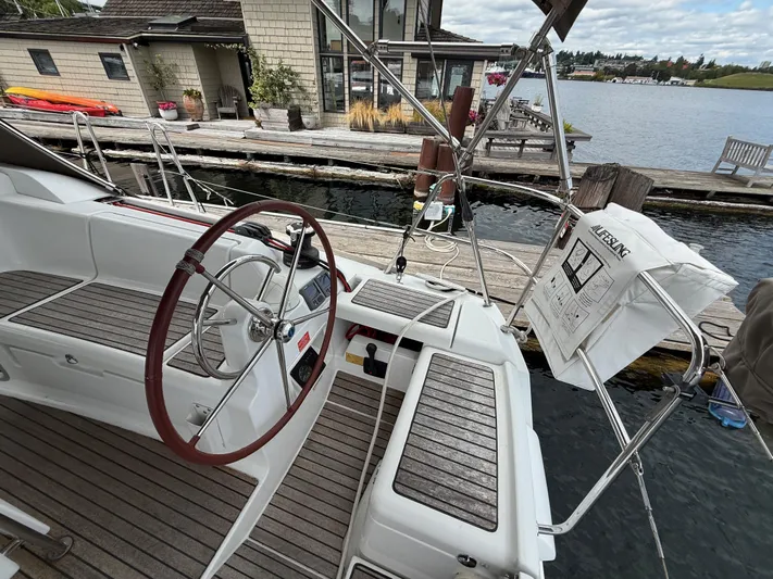 Kahuna Yacht Photos Pics Cockpit of 2011 Jeanneau 409 sailboat docked by a wooden pier.