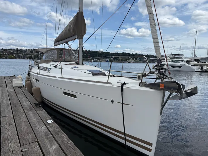 Kahuna Yacht Photos Pics 2011 Jeanneau 409 sailboat docked at a marina under a partly cloudy sky.