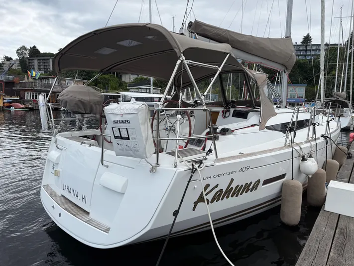 Kahuna Yacht Photos Pics 2011 Jeanneau 409 sailboat docked, featuring a spacious deck and protective canopy.