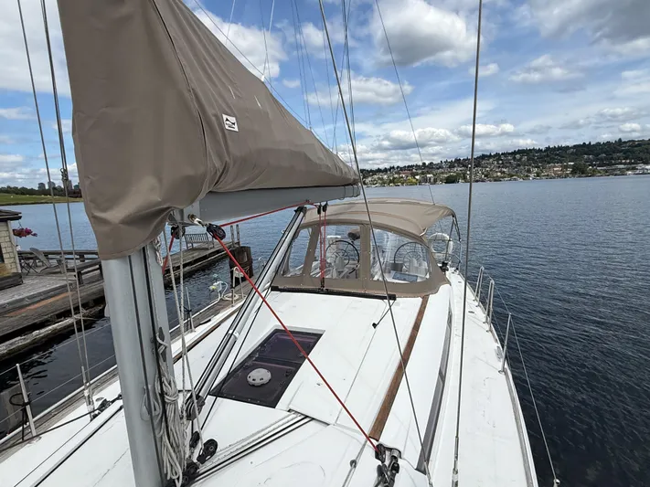 Kahuna Yacht Photos Pics 2011 Jeanneau 409 sailboat docked on calm water under a partly cloudy sky.