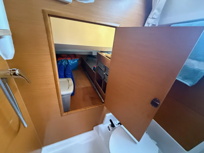 Kahuna Yacht Photos Pics Interior view of 2011 Jeanneau 409 sailboat, featuring a wooden storage compartment.