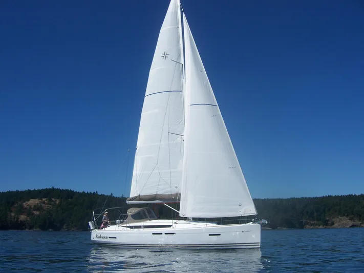 Kahuna Yacht Photos Pics 2011 Jeanneau 409 sailboat on calm water under clear blue sky.