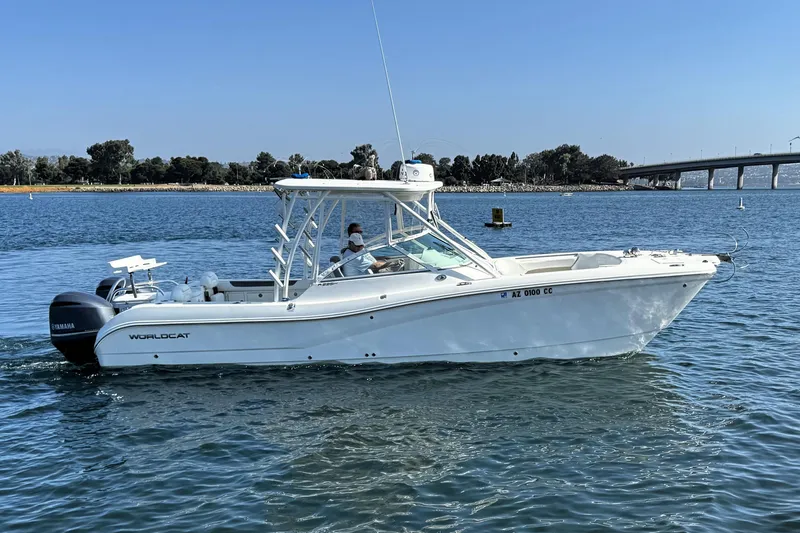  Yacht Photos Pics 2017 World Cat 295 DC boat cruising on a sunny day near a bridge.