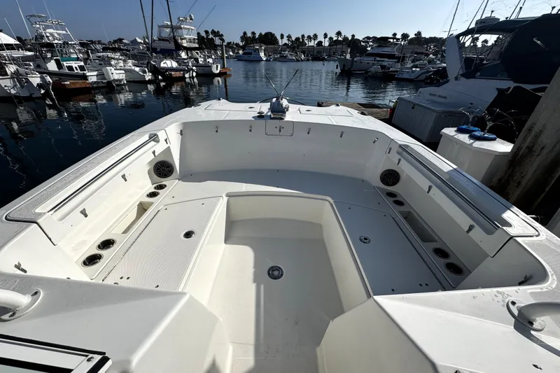 Yacht Photos Pics 2017 World Cat 295 DC boat interior at marina, showcasing spacious seating and storage.