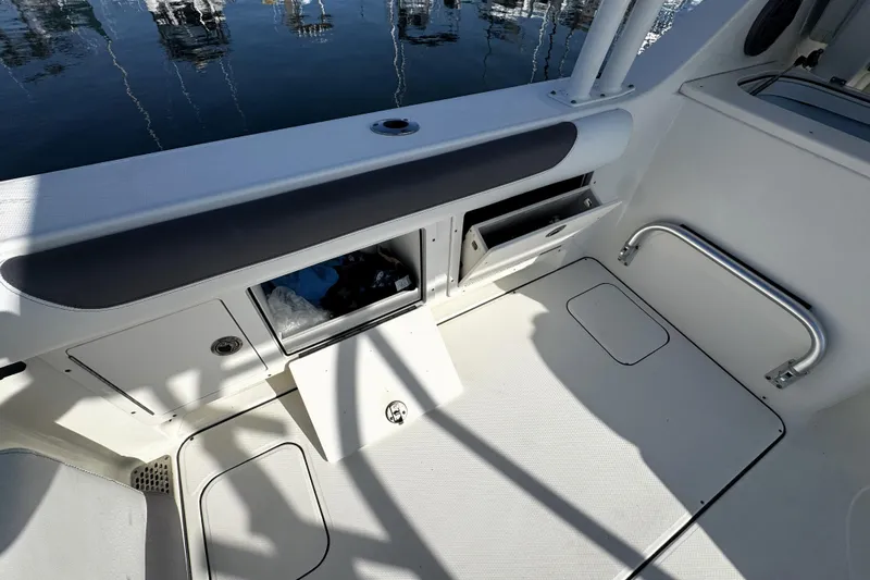  Yacht Photos Pics 2017 World Cat 295 DC boat interior with storage compartments and seating.