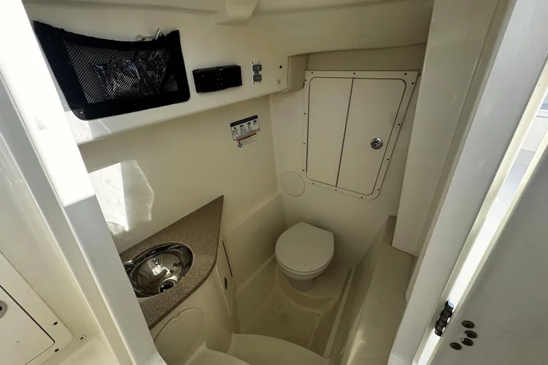  Yacht Photos Pics Interior of 2017 World Cat 295 DC boat bathroom with sink and toilet.