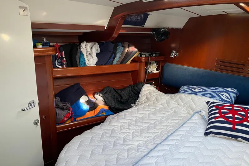Milos Dream Yacht Photos Pics Cozy cabin interior of 2003 Beneteau Oceanis 50 sailboat with bedding and storage.