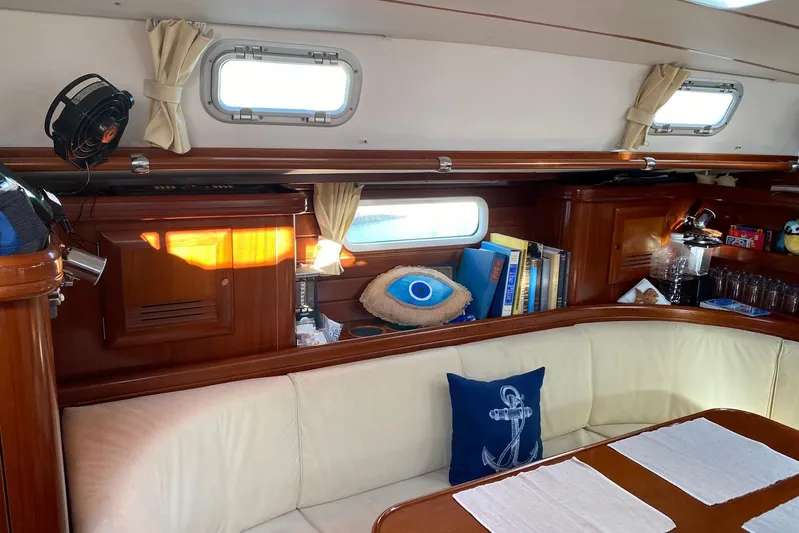 Milos Dream Yacht Photos Pics Interior of 2003 Beneteau Oceanis 50 yacht with cozy seating and nautical decor.