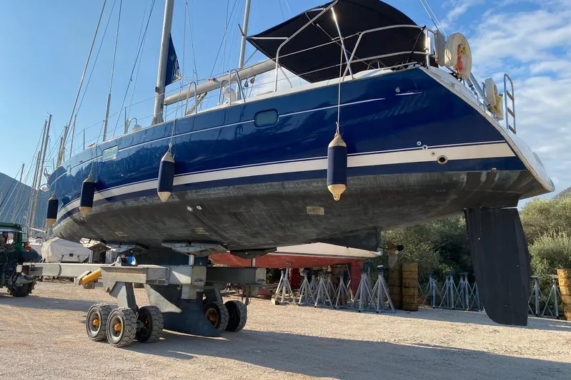 Milos Dream Yacht Photos Pics 2003 Beneteau Oceanis 50 sailboat on trailer, blue hull, outdoor setting.