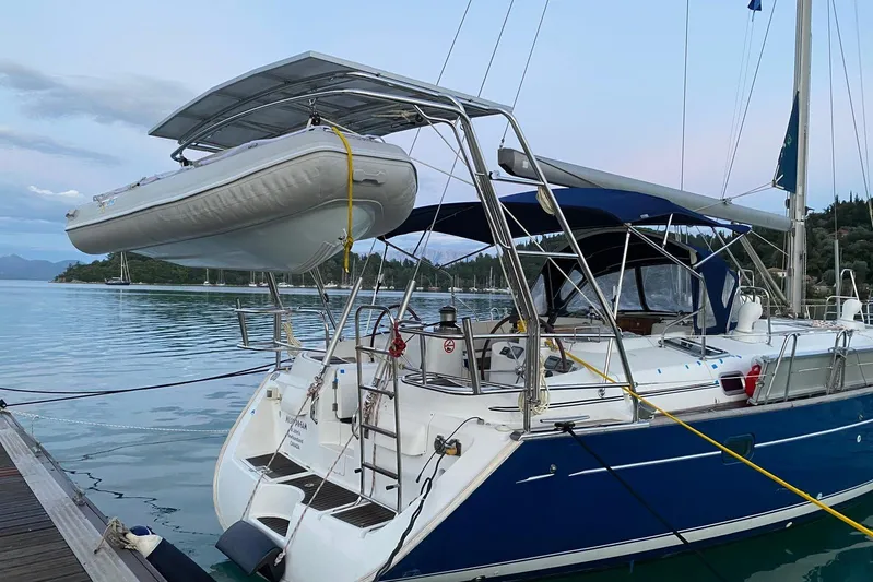 Milos Dream Yacht Photos Pics Beneteau Oceanis 50 sailboat, 2003 model, docked with dinghy on davits.