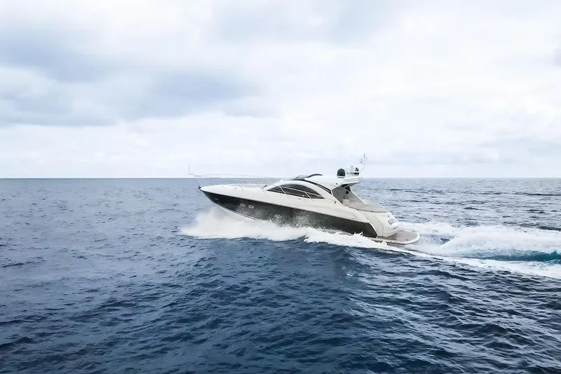 Aquaholic Yacht Photos Pics 2013 Sunseeker Portafino yacht cruising on open sea under cloudy sky.