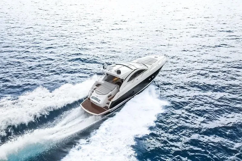 Aquaholic Yacht Photos Pics 2013 Sunseeker Portafino yacht cruising on open water, aerial view.