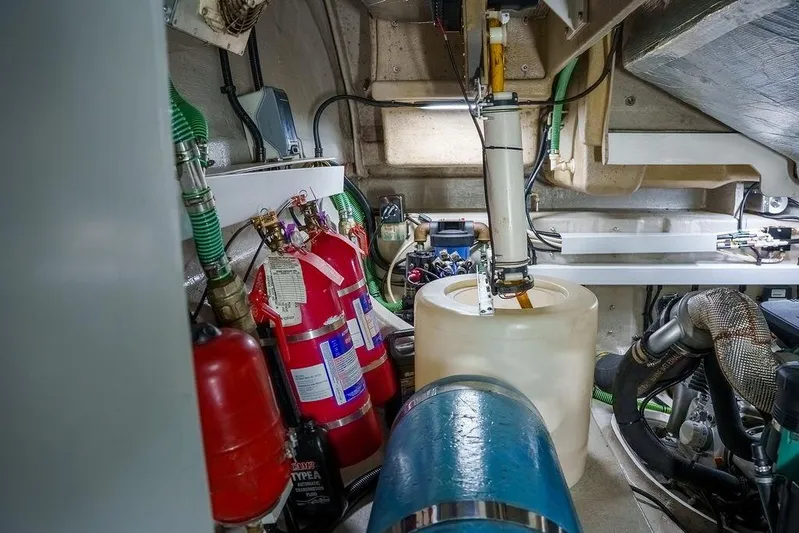 Aquaholic Yacht Photos Pics Engine room of 2013 Sunseeker Portafino yacht with fire extinguishers and mechanical components.