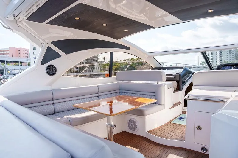 Aquaholic Yacht Photos Pics Luxurious interior of 2013 Sunseeker Portafino yacht with elegant seating and wooden table.