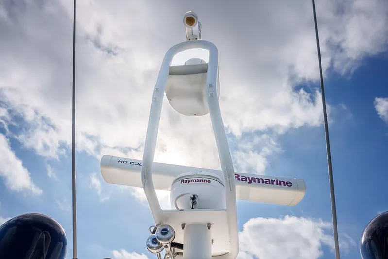 Aquaholic Yacht Photos Pics Radar equipment on a 2013 Sunseeker Portafino yacht against a cloudy sky.