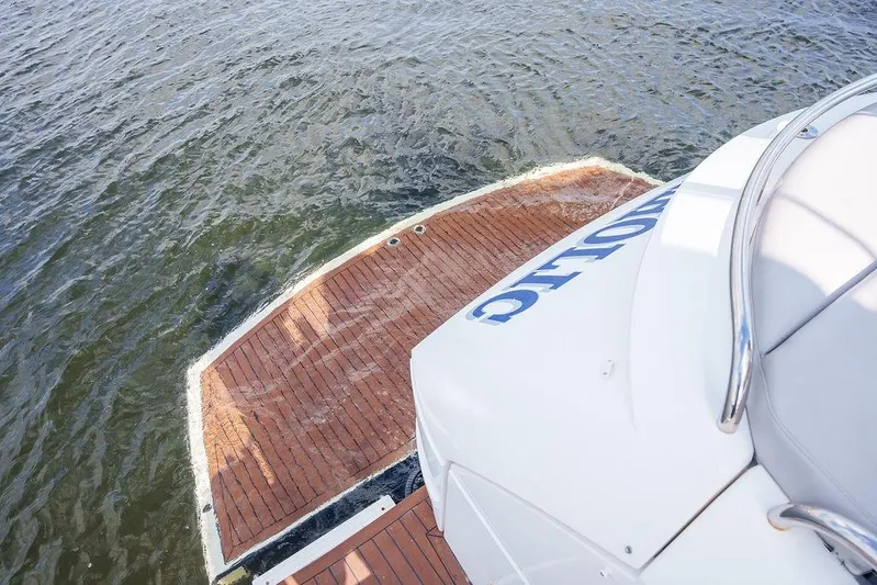 Aquaholic Yacht Photos Pics 2013 Sunseeker Portafino yacht with wooden deck, on calm water.