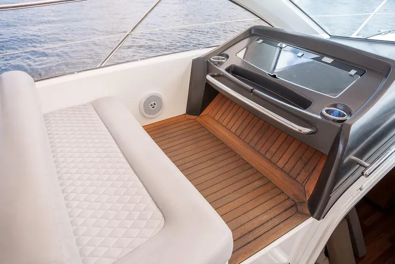 Aquaholic Yacht Photos Pics 2013 Sunseeker Portafino yacht interior with cushioned seating and wooden flooring.