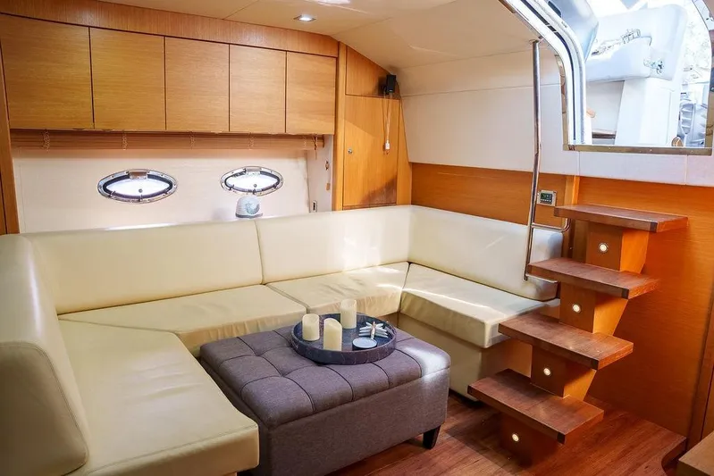 Aquaholic Yacht Photos Pics Luxurious interior of 2013 Sunseeker Portafino yacht with cream leather seating and wooden accents.