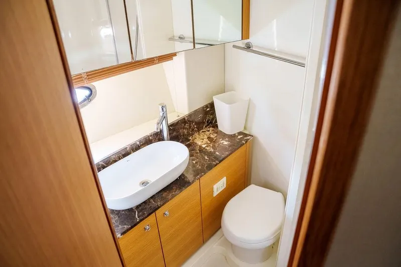 Aquaholic Yacht Photos Pics Luxurious bathroom in 2013 Sunseeker Portafino yacht with marble countertop and modern fixtures.