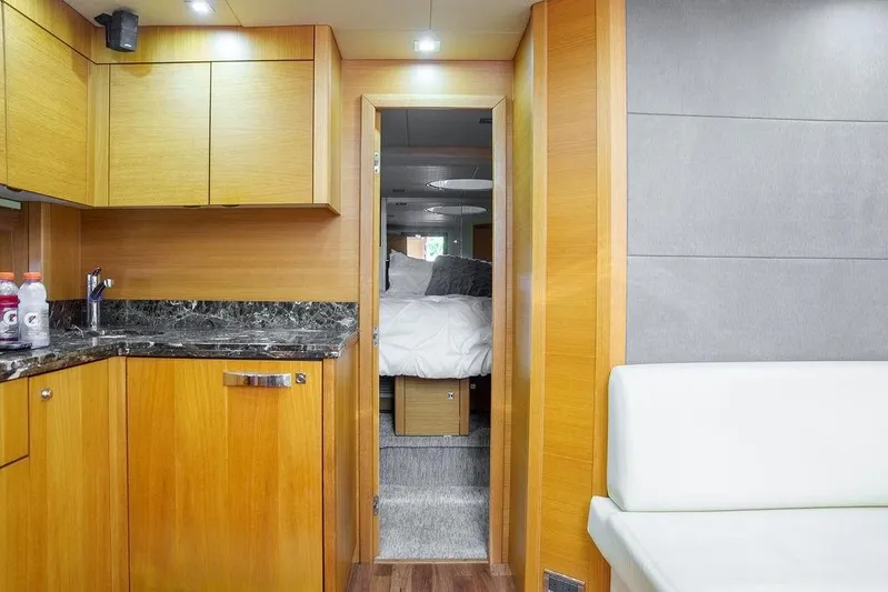 Aquaholic Yacht Photos Pics Interior of 2013 Sunseeker Portafino yacht with modern kitchen and cozy bedroom.