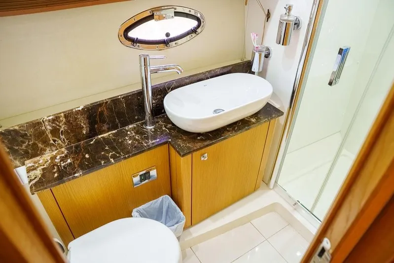 Aquaholic Yacht Photos Pics Luxurious bathroom in 2013 Sunseeker Portafino yacht with marble countertop and modern fixtures.