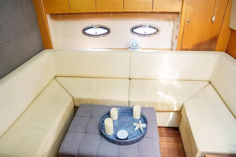 Aquaholic Yacht Photos Pics Luxurious interior of 2013 Sunseeker Portafino yacht with cream seating and decorative accents.
