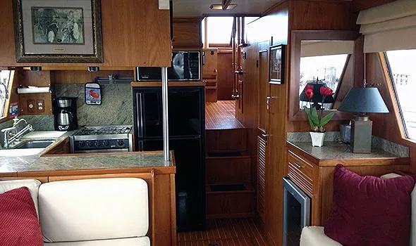 Hullabaloo Yacht Photos Pics Interior of 1986 Sea Ranger 47 Pilothouse with kitchen and cozy seating area.