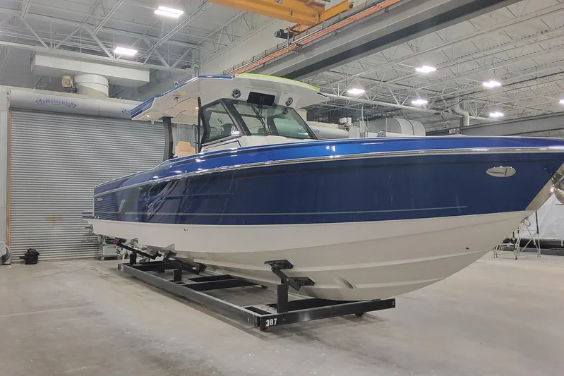  Yacht Photos Pics 2024 Formula 387 Center Console Fish boat in a warehouse setting.