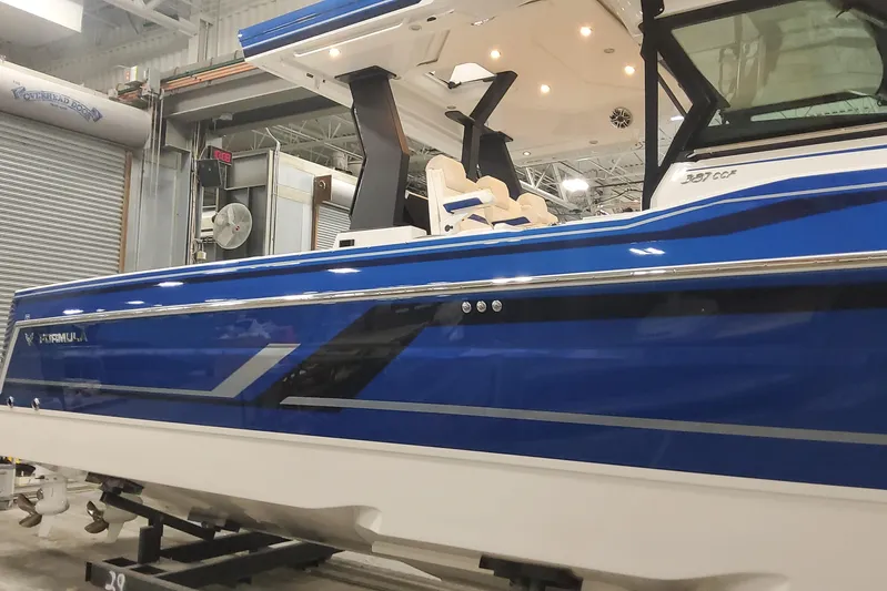  Yacht Photos Pics 2024 Formula 387 Center Console Fish boat in a showroom, featuring sleek blue design.