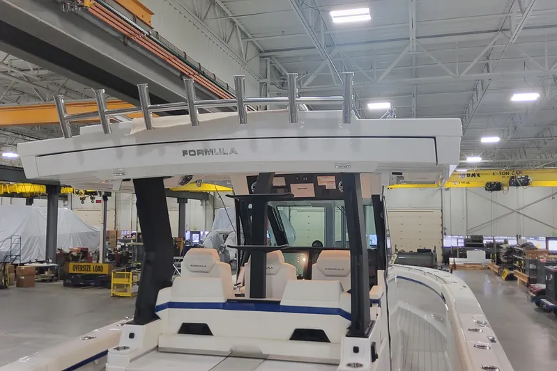  Yacht Photos Pics 2024 Formula 387 Center Console Fish boat in a spacious indoor facility.