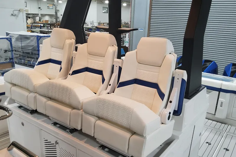  Yacht Photos Pics 2024 Formula 387 Center Console Fish boat with luxurious seating in a showroom.