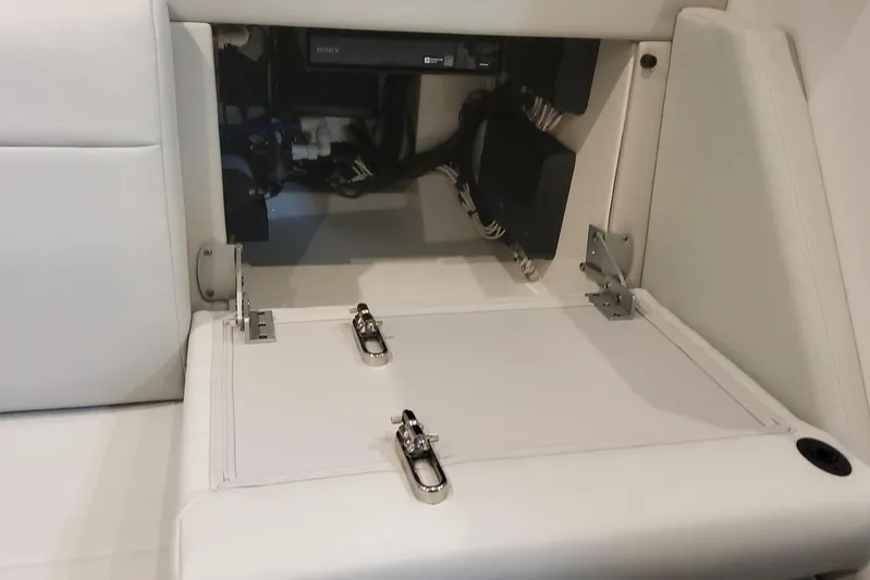 Yacht Photos Pics 2024 Formula 387 Center Console Fish boat interior storage compartment with white cushioned seating.