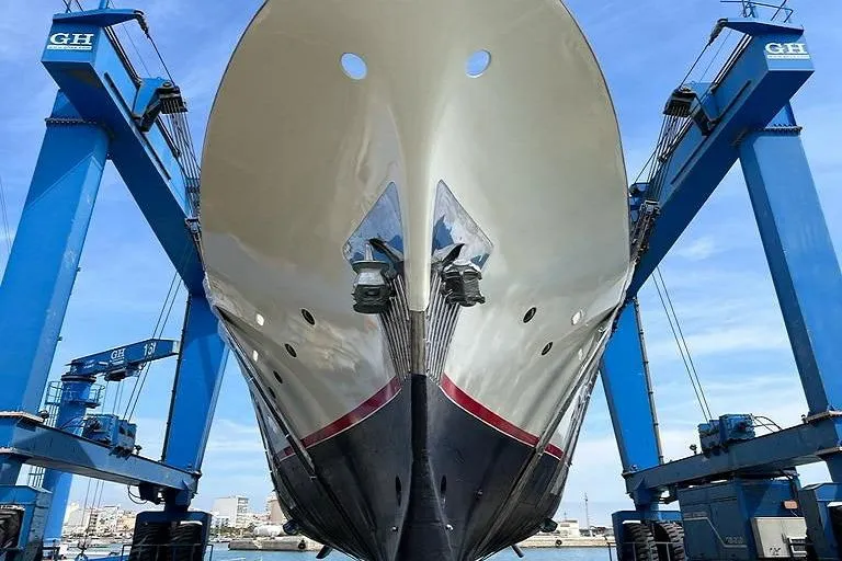  Yacht Photos Pics Explorer Trawler 34m 2005 yacht in dry dock, supported by blue cranes.