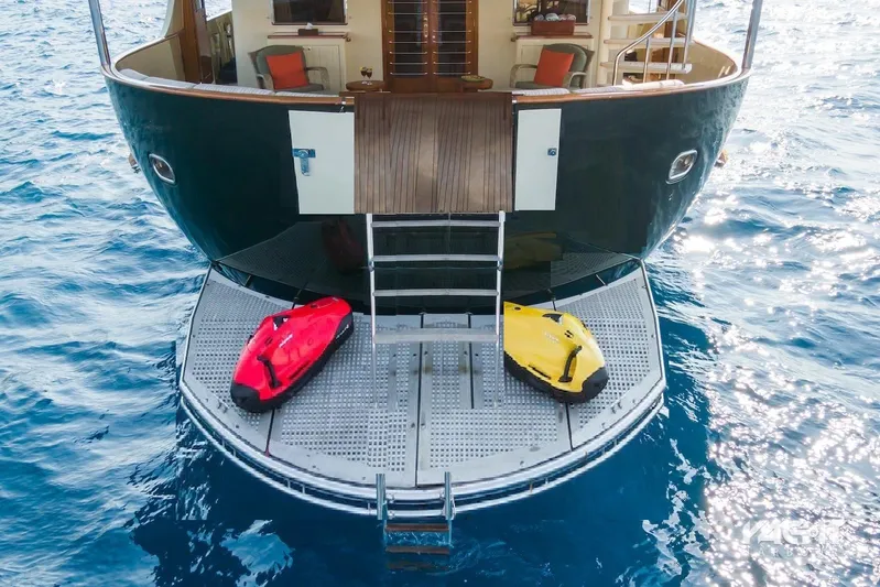  Yacht Photos Pics Explorer Trawler 34m yacht stern with water toys, 2005 model, on calm sea.