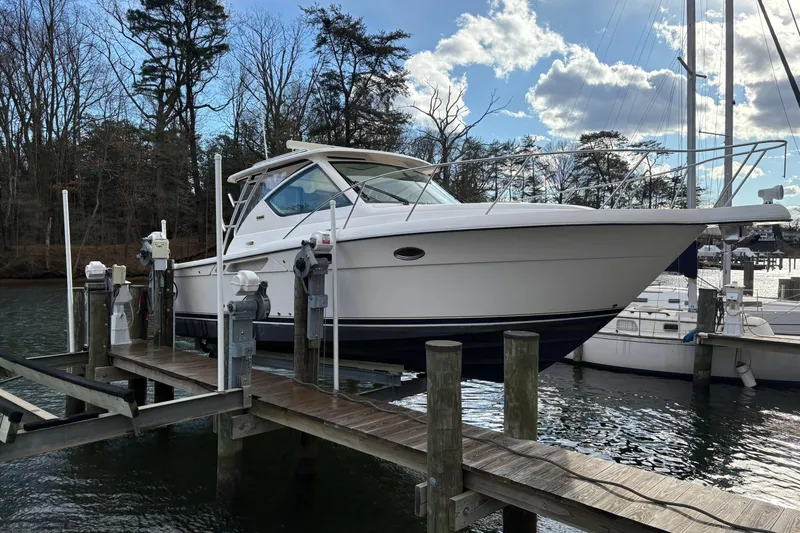  Yacht Photos Pics 2008 Tiara Yachts 3000 Open docked at a marina with trees in the background.