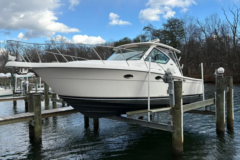  Yacht Photos Pics 2008 Tiara Yachts 3000 Open on lift, docked by a serene waterfront.