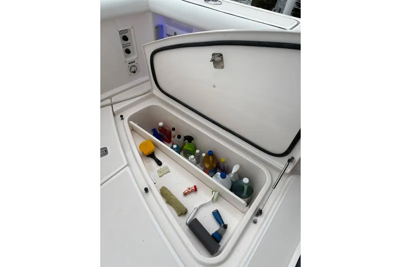  Yacht Photos Pics Storage compartment on a 2008 Tiara Yachts 3000 Open, containing cleaning supplies.
