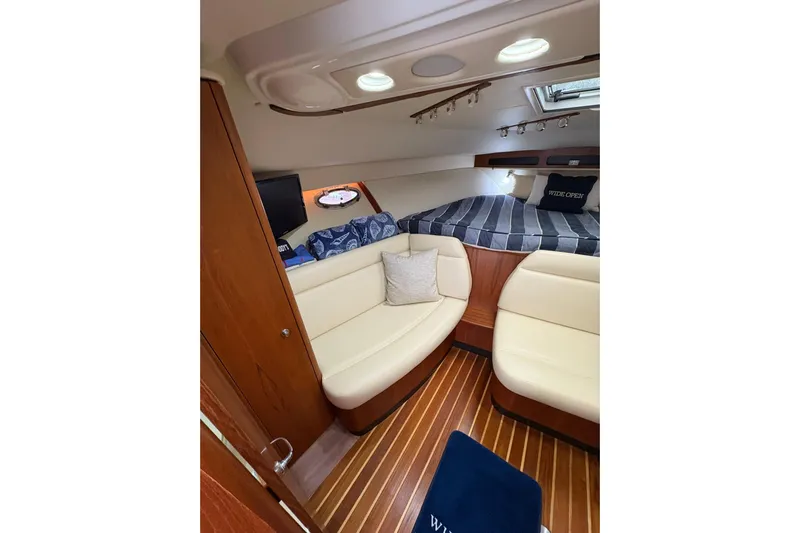  Yacht Photos Pics Luxurious interior of 2008 Tiara Yachts 3000 Open with cozy seating and elegant wood finishes.