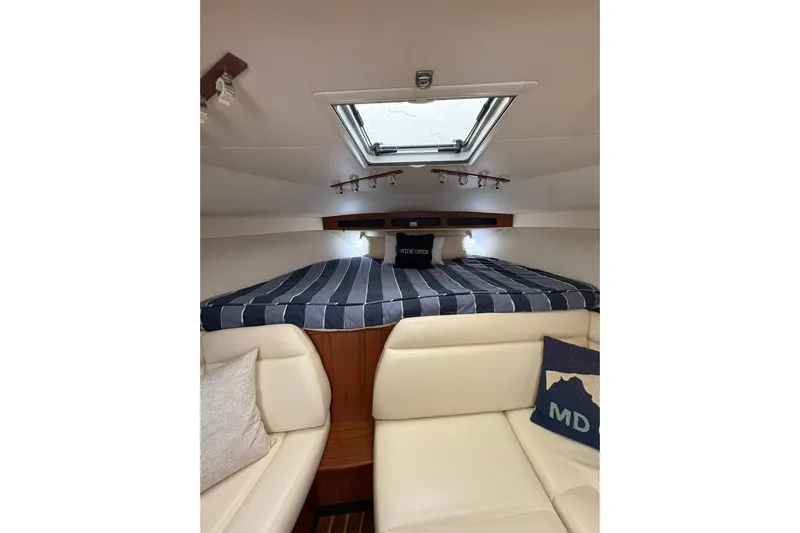  Yacht Photos Pics 2008 Tiara Yachts 3000 Open cabin interior with striped bedding and skylight.
