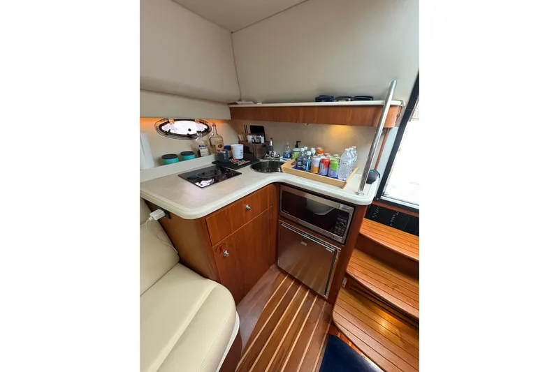  Yacht Photos Pics Compact galley in 2008 Tiara Yachts 3000 Open, featuring stove, sink, and microwave.